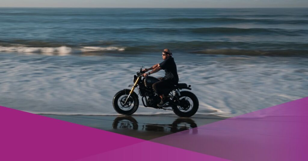 A man ride a motorcycle at one of Bali's beaches